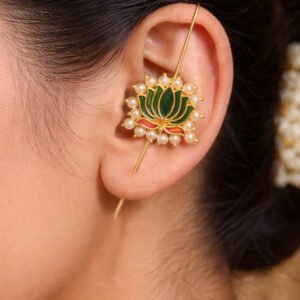 Woman wearing gold lotus needle ear cuff with pearl by Lumera