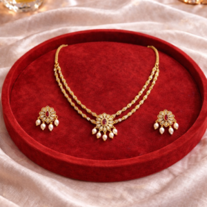Gold double line necklace set with ruby centre stone pearl drops and matching earrings by Lumera