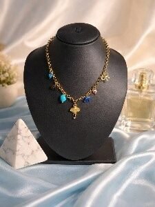 Gold elephant pendant charm necklace with blue stone and cross charms by Lumera