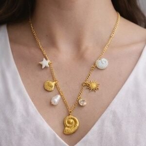 Gold big spiral shell charm necklace with ocean charms and pearl by Lumera