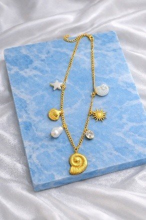 Golden Spiral Shell Charm Necklace Big | Lumera Gold big spiral shell charm necklace with ocean charms and pearl by Lumera