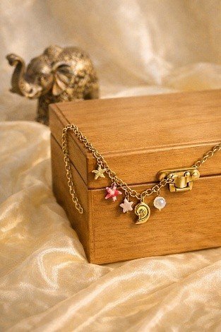Golden Spiral Shell Charm Necklace Small | Lumera Gold small spiral shell charm necklace with pink flower star and crystal charms by Lumera