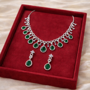 Woman wearing silver emerald necklace set with matching earrings by Lumera